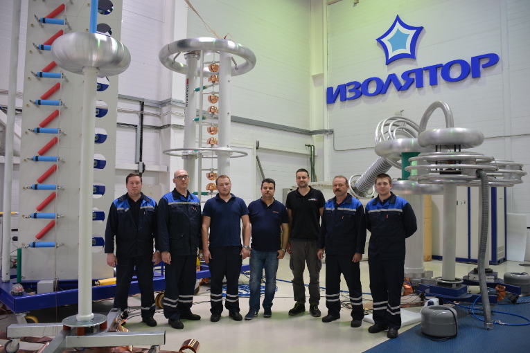 Experts who installed the surge generator of Haefely Test AG at the test center of Izolyator, in the center — Dmitry Ivanov